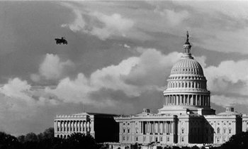 Movie still from “The Absent Minded Professor” (1961), directed by Robert Stevenson – An airplane flying over the capitol building in washington d; Extreme Wide shot, Low angle