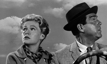 Movie still from “The Absent Minded Professor” (1961), directed by Robert Stevenson – An old photo of a man and a woman looking at each other; Close Up shot, Low angle