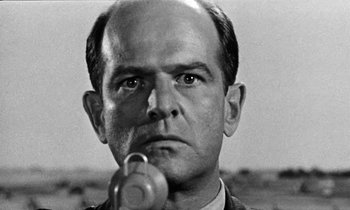 Movie still from “The Absent Minded Professor” (1961), directed by Robert Stevenson – An older man is holding something in his mouth; Close Up shot, Low angle