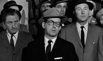 Movie still from “The Absent Minded Professor” (1961), directed by Robert Stevenson – Black and white photograph of a man wearing a hat; Medium shot, Over the shoulder angle