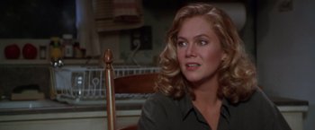 Movie still from “The Accidental Tourist” (1988), directed by Lawrence Kasdan – A woman sitting in a chair looking to her left; Close Up shot, Over the shoulder angle