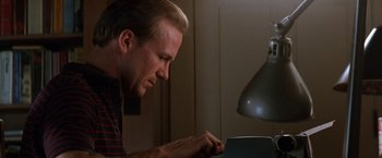 Movie still from “The Accidental Tourist” (1988), directed by Lawrence Kasdan – A person using a computer; Close Up shot, Low angle