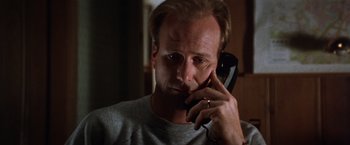 Movie still from “The Accidental Tourist” (1988), directed by Lawrence Kasdan – A person talking on a cell phone; Close Up shot, Low angle