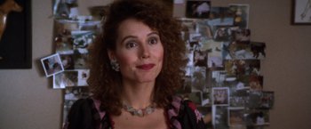 Movie still from “The Accidental Tourist” (1988), directed by Lawrence Kasdan – A person with curly hair wearing a necklace; Close Up shot, Over the shoulder angle