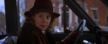 Movie still from “The Accidental Tourist” (1988), directed by Lawrence Kasdan – A woman sitting in the drivers seat of a car; Close Up shot, Over the shoulder angle
