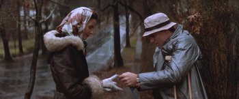 Movie still from “The Accidental Tourist” (1988), directed by Lawrence Kasdan – An older man and a younger woman exchanging gloves; Medium shot, High angle