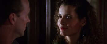 Movie still from “The Accidental Tourist” (1988), directed by Lawrence Kasdan – A person with curly brown hair; Close Up shot, Over the shoulder angle