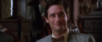 Movie still from “The Accidental Tourist” (1988), directed by Lawrence Kasdan – A man wearing a suit and a bow tie; Close Up shot, Low angle