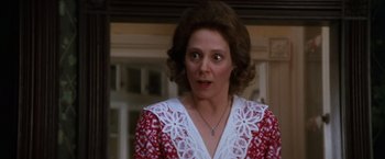 Movie still from “The Accidental Tourist” (1988), directed by Lawrence Kasdan – A person wearing a red and white dress; Close Up shot, Over the shoulder angle