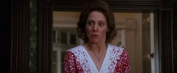 Movie still from “The Accidental Tourist” (1988), directed by Lawrence Kasdan – A person wearing a red and white dress; Close Up shot, Low angle