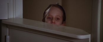 Movie still from “The Accidental Tourist” (1988), directed by Lawrence Kasdan – A little girl peeking over a ledge at the camera; Close Up shot, Low angle