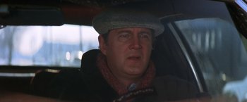 Movie still from “The Accidental Tourist” (1988), directed by Lawrence Kasdan – A person in a car wearing a hat; Close Up shot, Over the shoulder angle