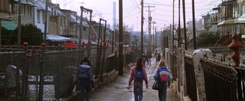 Movie still from “The Accidental Tourist” (1988), directed by Lawrence Kasdan – A group of people walking down a sidewalk; Wide shot, High angle