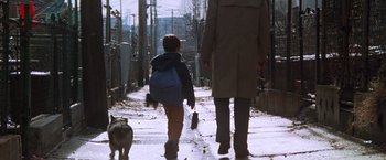 Movie still from “The Accidental Tourist” (1988), directed by Lawrence Kasdan – A man and a child walking down a sidewalk; Wide shot, Low angle