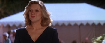 Movie still from “The Accidental Tourist” (1988), directed by Lawrence Kasdan – A woman with blonde hair wearing a black dress; Close Up shot, Over the shoulder angle