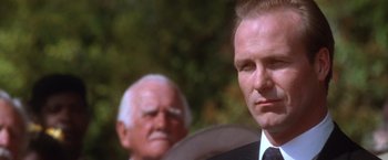 Movie still from “The Accidental Tourist” (1988), directed by Lawrence Kasdan – A person wearing a suit and tie; Close Up shot, Low angle