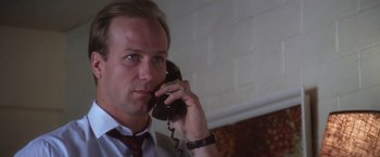 Movie still from “The Accidental Tourist” (1988), directed by Lawrence Kasdan – A person talking on a phone; Close Up shot, Low angle