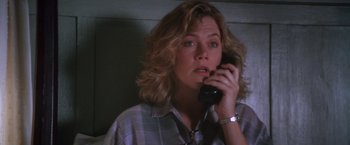 Movie still from “The Accidental Tourist” (1988), directed by Lawrence Kasdan – A woman talking on a phone while sitting down; Close Up shot, Low angle