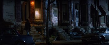 Movie still from “The Accidental Tourist” (1988), directed by Lawrence Kasdan – A night time picture of some steps and a building; Extreme Wide shot, High angle