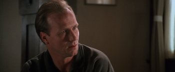 Movie still from “The Accidental Tourist” (1988), directed by Lawrence Kasdan – A person sitting in front of a window; Close Up shot, Over the shoulder angle