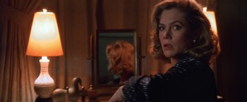 Movie still from “The Accidental Tourist” (1988), directed by Lawrence Kasdan – A woman standing in front of a bathroom mirror; Close Up shot, Over the shoulder angle