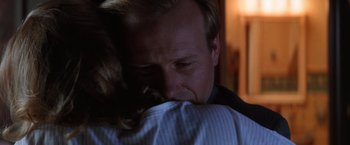 Movie still from “The Accidental Tourist” (1988), directed by Lawrence Kasdan – A person hugging another person; Close Up shot, Over the shoulder angle