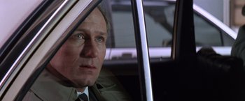 Movie still from “The Accidental Tourist” (1988), directed by Lawrence Kasdan – A person sitting in a car; Close Up shot, Low angle