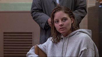 Movie still from “The Accused” (1988), directed by Jonathan Kaplan – A woman sitting in front of a man in a courtroom; Close Up shot, Low angle