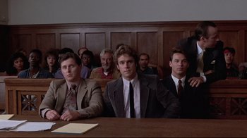 Movie still from “The Accused” (1988), directed by Jonathan Kaplan – A group of people sitting in a courtroom; Medium shot, Low angle