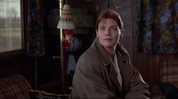 Movie still from “The Accused” (1988), directed by Jonathan Kaplan – A woman sitting in front of a lamp in a room; Close Up shot, Low angle