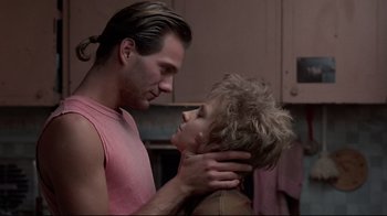 Movie still from “The Accused” (1988), directed by Jonathan Kaplan – A man and a woman face to face in a room; Close Up shot, Low angle