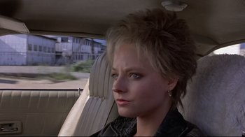 Movie still from “The Accused” (1988), directed by Jonathan Kaplan – A woman sitting in the back seat of a car; Close Up shot, Over the shoulder angle