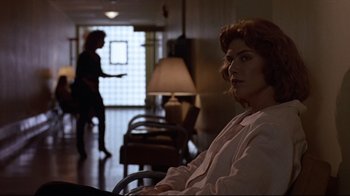 Movie still from “The Accused” (1988), directed by Jonathan Kaplan – A woman sitting in a chair in front of another woman; Medium shot, Over the shoulder angle
