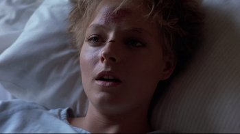 Movie still from “The Accused” (1988), directed by Jonathan Kaplan – A person laying in a bed; Close Up shot, Overhead angle