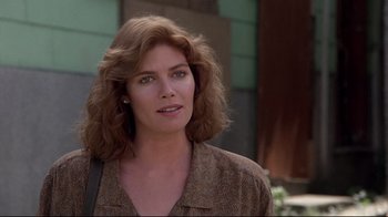 Movie still from “The Accused” (1988), directed by Jonathan Kaplan – A person with long hair; Close Up shot, Over the shoulder angle