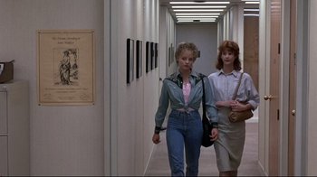 Movie still from “The Accused” (1988), directed by Jonathan Kaplan – Two women are walking down a hallway in a building; Wide shot, Low angle