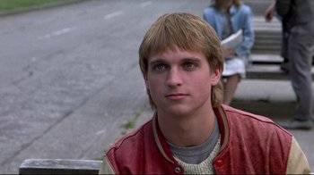 Movie still from “The Accused” (1988), directed by Jonathan Kaplan – A man with long blonde hair wearing a red jacket; Close Up shot, Low angle