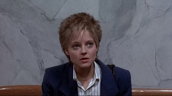 Movie still from “The Accused” (1988), directed by Jonathan Kaplan – A person wearing a suit and tie; Close Up shot, Low angle