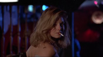 Movie still from “The Accused” (1988), directed by Jonathan Kaplan – A woman is smoking a cigarette in the dark; Close Up shot, Low angle