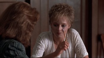 Movie still from “The Accused” (1988), directed by Jonathan Kaplan – A woman is holding a pencil in her hand; Close Up shot, Over the shoulder angle