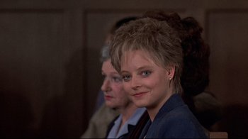 Movie still from “The Accused” (1988), directed by Jonathan Kaplan – A woman in a blue jacket and a man in a blue jacket; Close Up shot, Over the shoulder angle