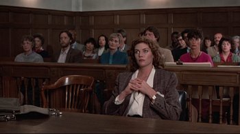 Movie still from “The Accused” (1988), directed by Jonathan Kaplan – A group of people sitting in a court room; Medium shot, Low angle