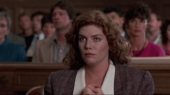 Movie still from “The Accused” (1988), directed by Jonathan Kaplan – A person sitting in front of a group of people; Close Up shot, Low angle
