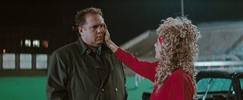 Movie still from “The Adjuster” (1991), directed by Atom Egoyan – A man and a woman are touching their faces together; Close Up shot, Over the shoulder angle