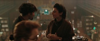 Movie still from “The Adjuster” (1991), directed by Atom Egoyan – A woman and a man are talking to each other; Medium shot, Over the shoulder angle