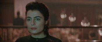 Movie still from “The Adjuster” (1991), directed by Atom Egoyan – A person wearing a black shirt; Close Up shot, Over the shoulder angle