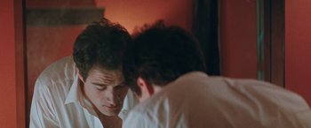 Movie still from “The Adjuster” (1991), directed by Atom Egoyan – Two men looking at each other in a mirror; Close Up shot, Over the shoulder angle