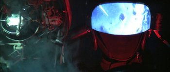 Movie still from “The Adventures of Buckaroo Banzai Across the 8th Dimension” (1984), directed by W.D. Richter – A television is shown with a blue light on it; Close Up shot, Low angle