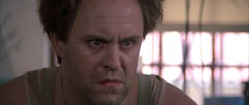 Movie still from “The Adventures of Buckaroo Banzai Across the 8th Dimension” (1984), directed by W.D. Richter – A man's face as he stares at the camera; Close Up shot, Low angle