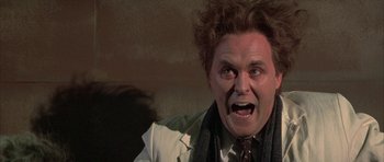 Movie still from “The Adventures of Buckaroo Banzai Across the 8th Dimension” (1984), directed by W.D. Richter – A person wearing a suit and tie; Close Up shot, Low angle